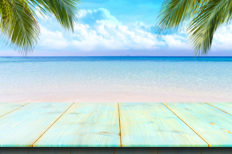 Wooden floor or plank on sand beach in summer. For product display.Calm Sea and Blue Sky Background