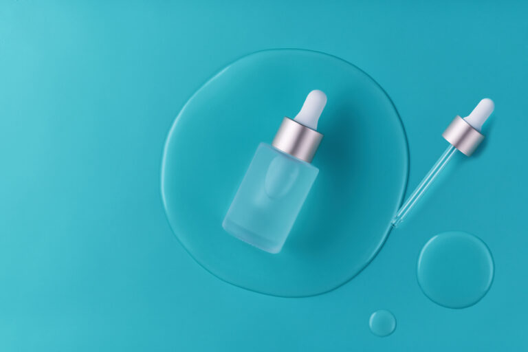 Cosmetics or skincare product ads with bottle and blue backgroun